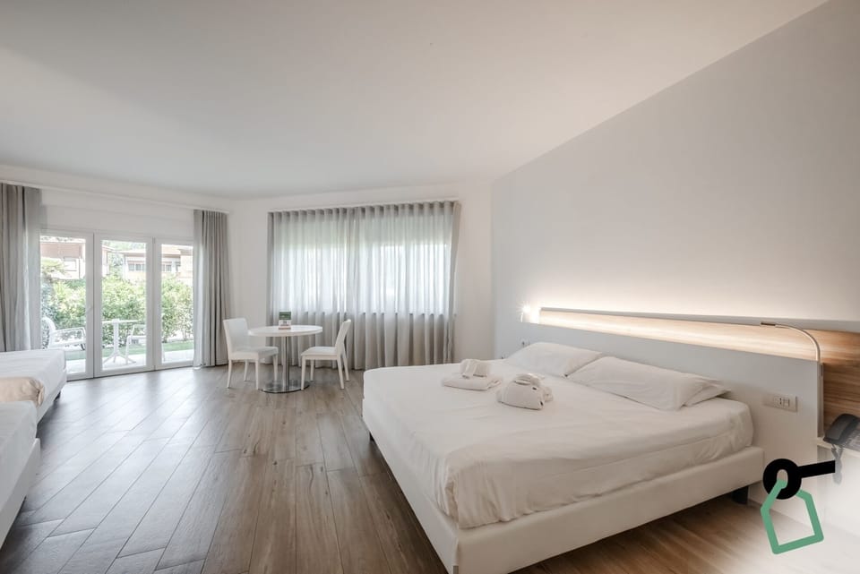 Comfort Quadruple Room, Patio | Minibar, in-room safe, desk, cribs/infant beds