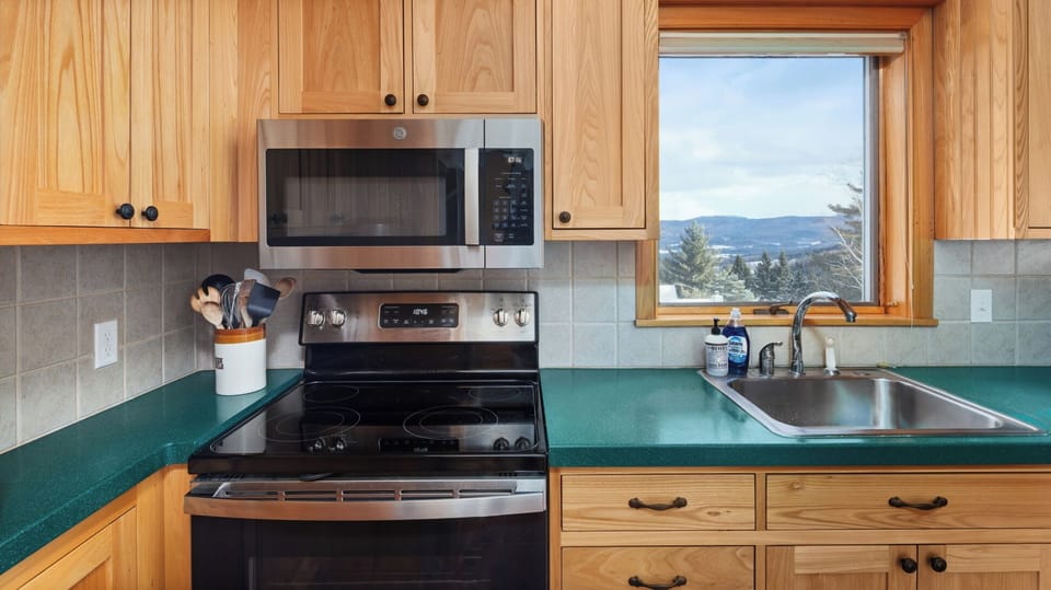 - Fully equipped kitchen with modern appliances and forest views   - Cook family meals while enjoying bright natural light   - Convenient space for preparing snacks and hearty dinners