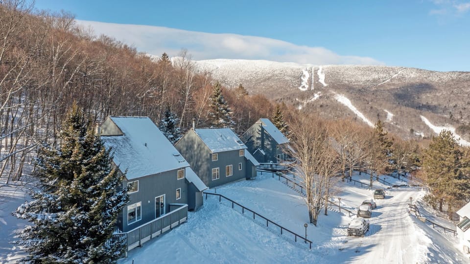 - Mountain cabin view with snow-covered rooftops and slopes   - Scenic location perfect for skiers and outdoor explorers   - Cozy retreat surrounded by forest and mountain beauty