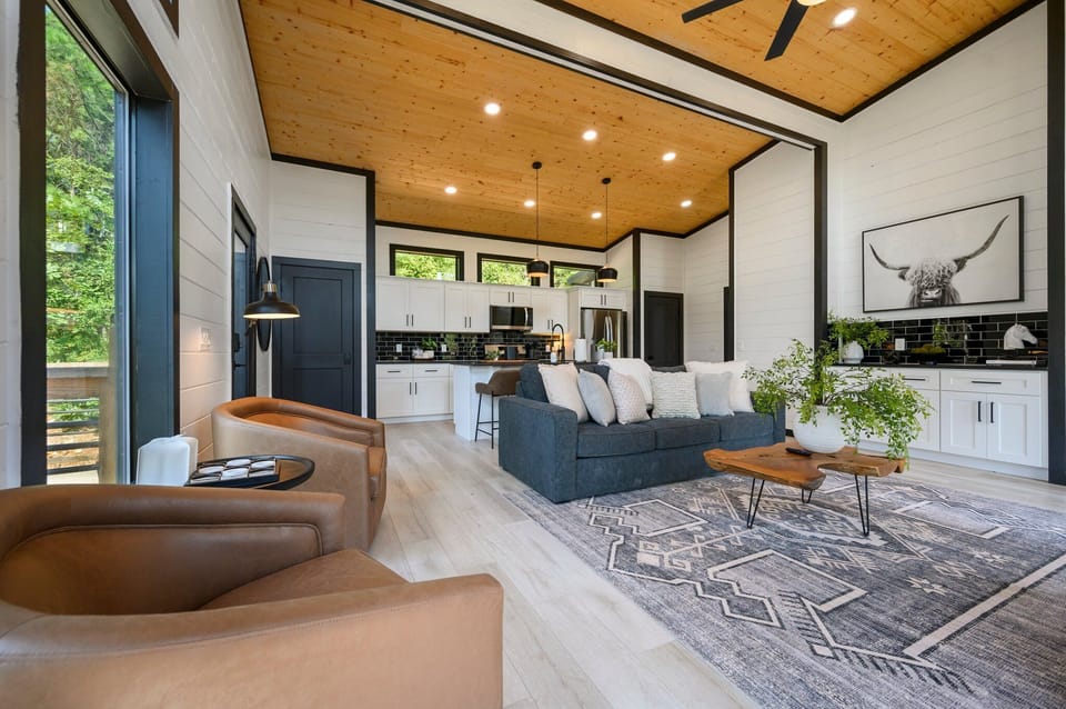 Modern mountain living at its finest! This stunning open-concept living space features soaring ceilings, a cozy fireplace, and breathtaking views.