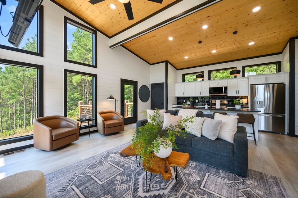 Modern meets rustic in this stunning open-concept living space with soaring ceilings and breathtaking views.
