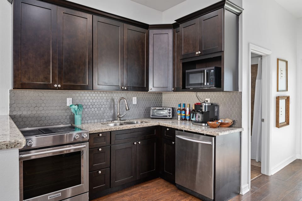Contemporary and well-equipped kitchen with sleek countertops, ample storage, and all the essentials to make meal preparation a breeze during your stay.