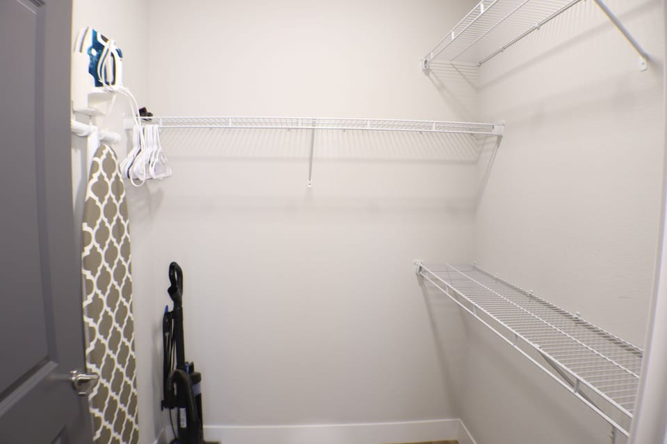 Primary Closet Offers Plenty of Storage and a Full Size Ironing Board and Iron. Spill Something? Use the Vacuum to Make the Clean-Up Simple. 