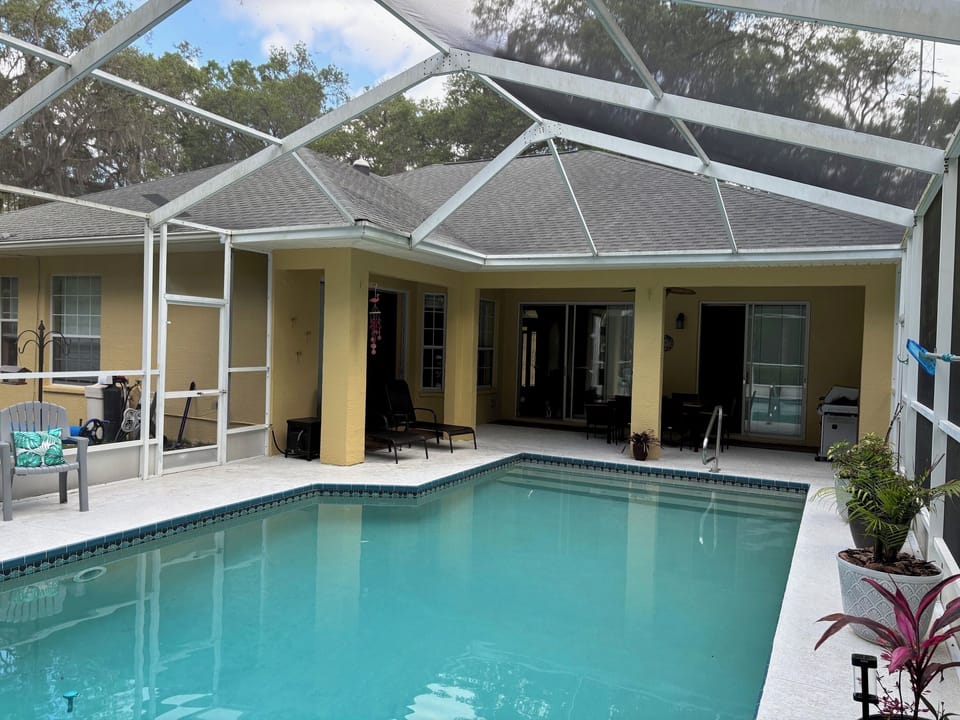 32' x 15' saltwater pool with tropical plantings around pool. 