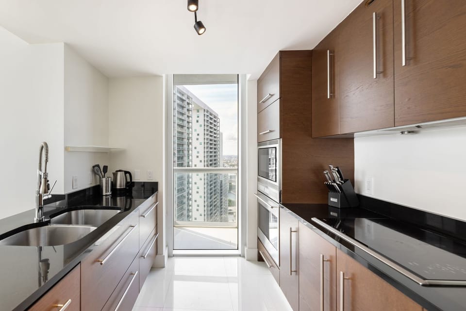 Contemporary galley-style kitchen with clean lines and warm wood tones.
