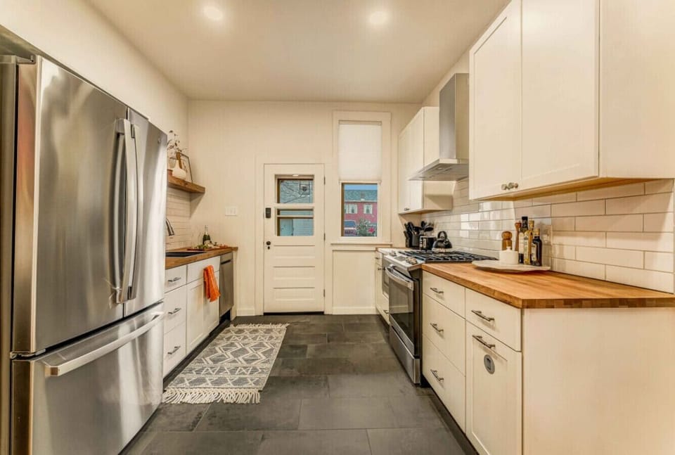 Welcome to the kitchen with a large fridge, ready to store all your essentials for a comfortable stay.