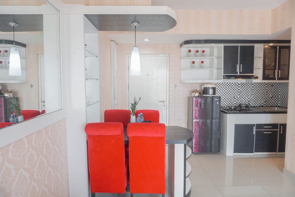 Full-size fridge, stovetop, rice cooker, dining tables