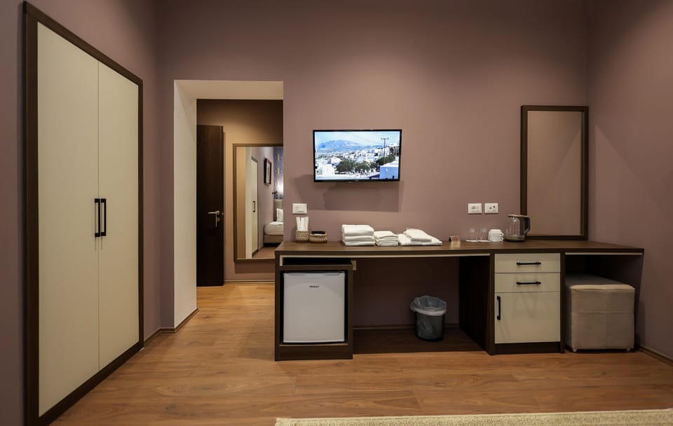 Deluxe Triple Room, Garden View | Minibar, in-room safe, desk, laptop workspace