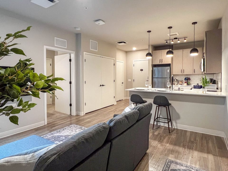 Modern and spacious, this open living area seamlessly connects to a fully equipped kitchen, creating a welcoming space to relax, cook, and enjoy your stay.