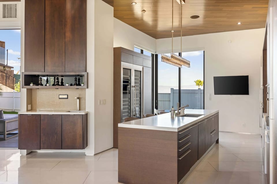 Kitchen: Island Sink, Custom Dark Wood Cabinets, Built-In Fridge & Mountain View