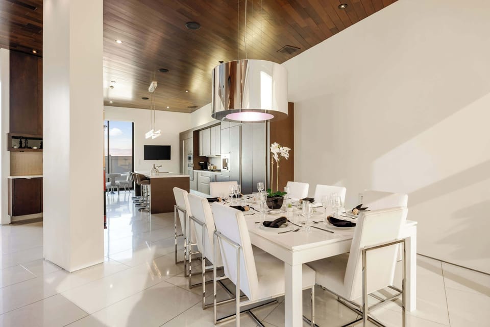 Dining Room: Formal Dining Setup with Chrome Drum Light & Kitchen View