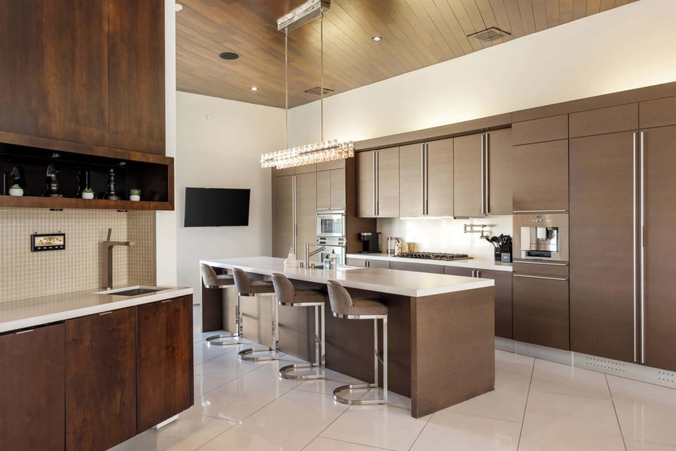 Chef's Kitchen: Island with Bar Seating, Double Wall Oven, Gas Range & Crystal Pendant