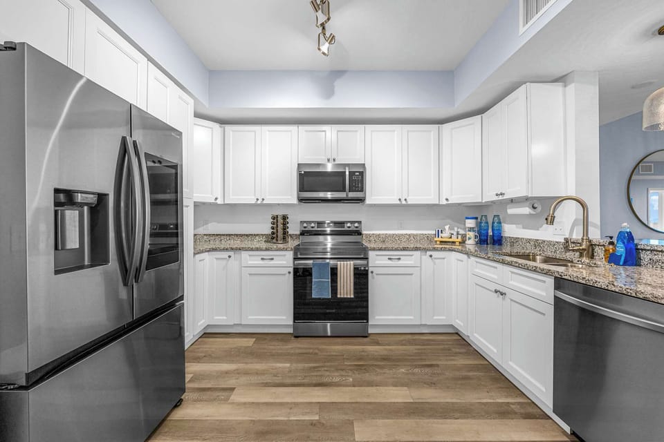 Modern kitchen with stainless steel appliances and granite countertops