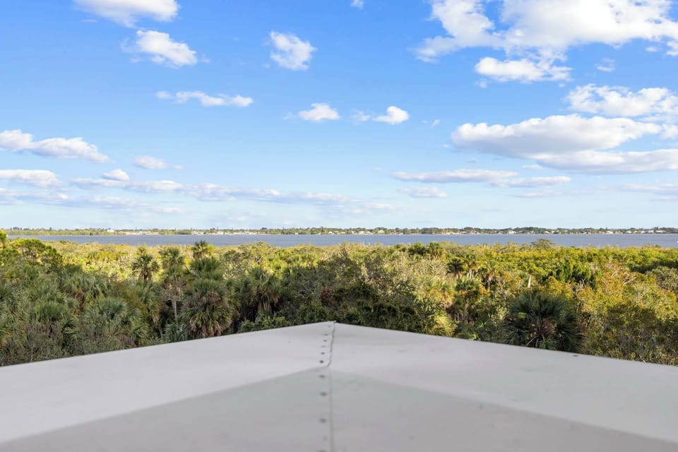 Scenic view of lush greenery and a calm lake under a clear blue sky