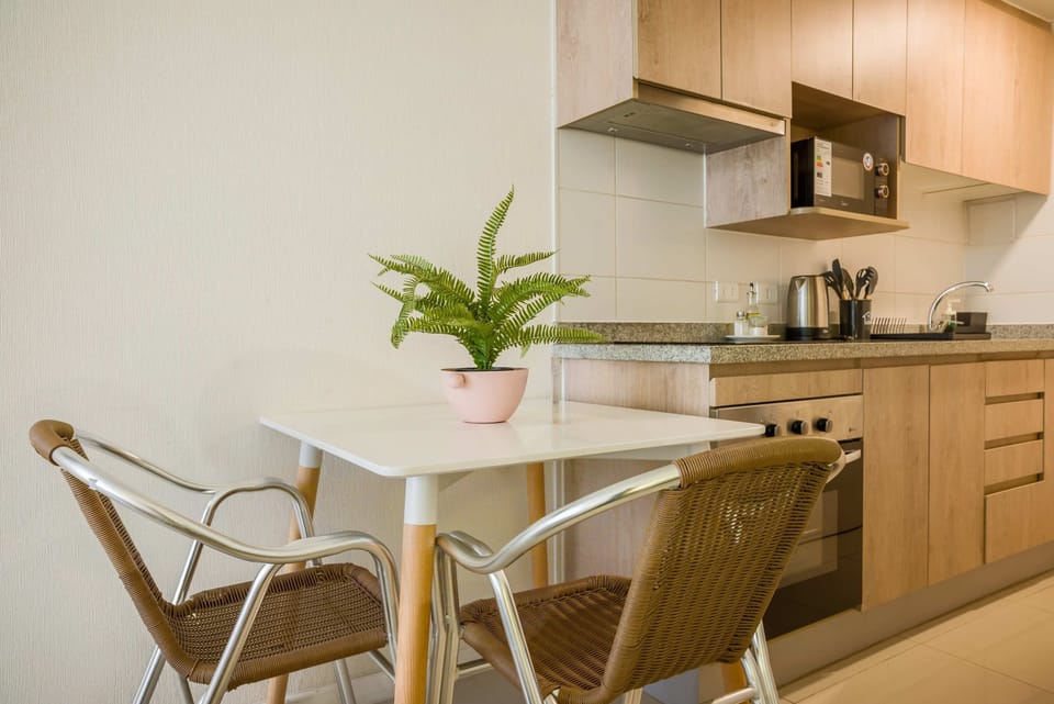 Cozy kitchen nook with modern amenities and stylish dining space, perfect for intimate meals.