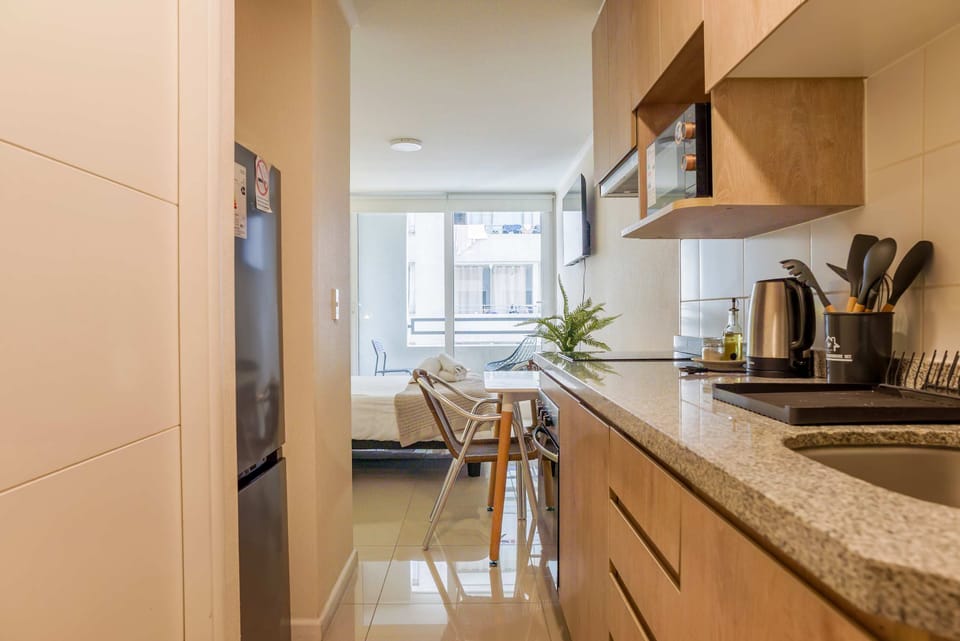 Cozy and modern kitchen with all essentials for a comfortable stay in the heart of the city.