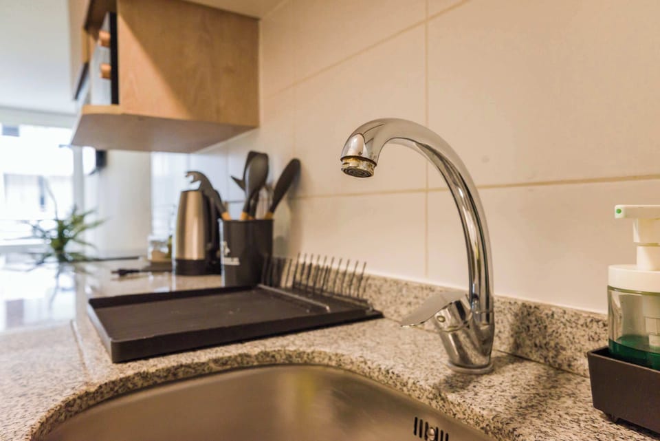 Modern kitchen with sleek granite countertops and essential appliances for a convenient stay.