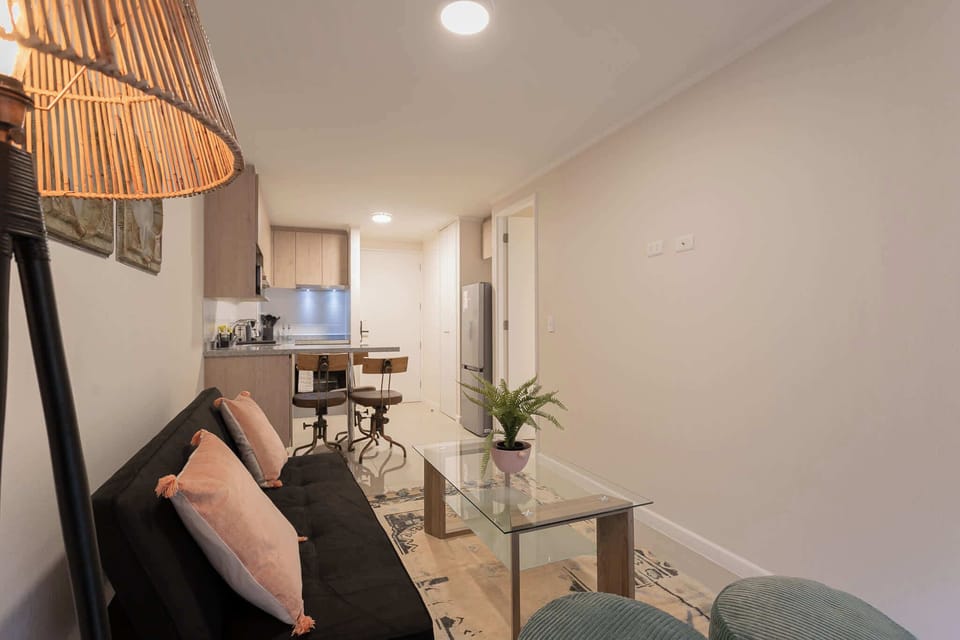 Modern living area with cozy seating and a sleek kitchen, ideal for relaxation and culinary adventures.