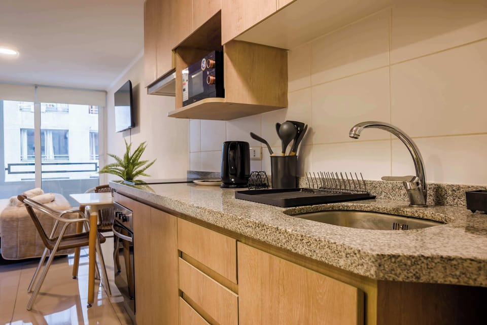 Cozy kitchen with modern amenities and a bright dining area, perfect for a comfortable stay.