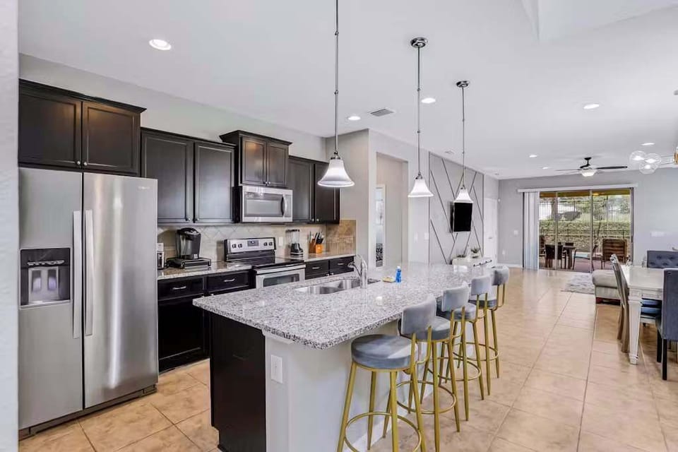 Large kitchen equipped with stainless steel appliances and everything you might need to make a delicious meal.