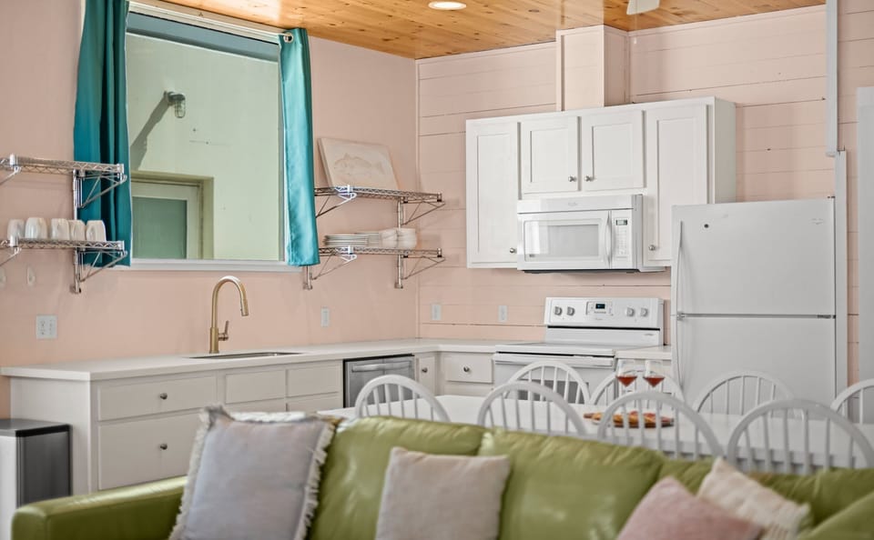 Kitchen Detail — White Cabinets, White Appliances, Gold Faucet, Chrome Shelves & Teal Curtains