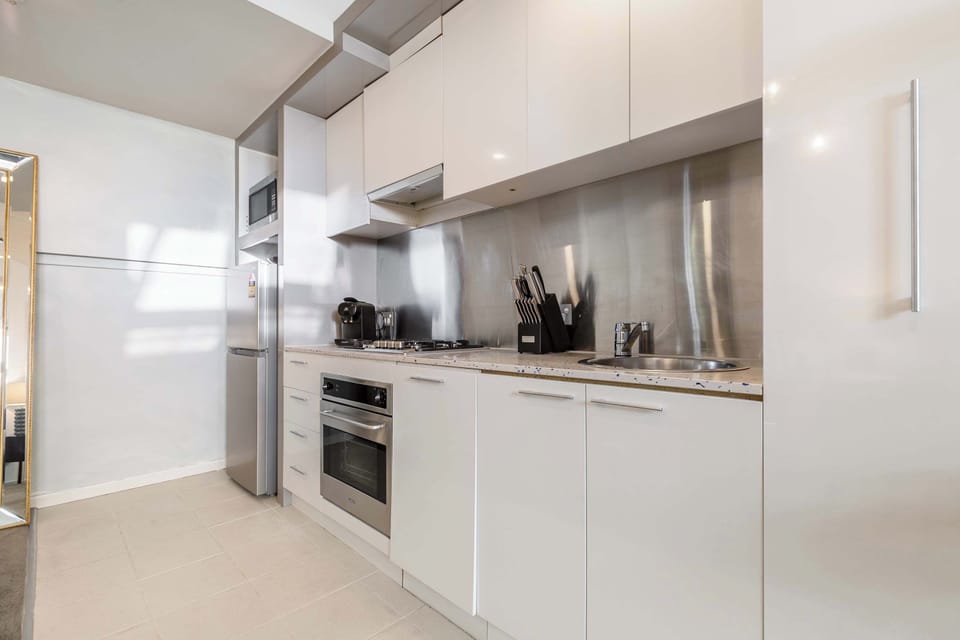 Kitchen at The Gilded Nook: Modern kitchen with sleek cabinetry, stainless steel appliances, and all essentials for home-style cooking