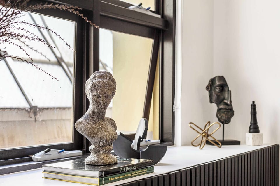 Artistic window display with sculptures and decor accents