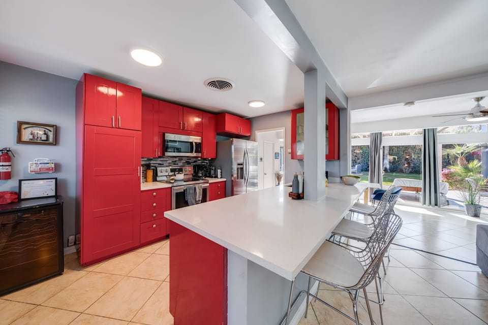 New countertops and backsplash, large refrigerator and freezer, espresso maker, coffee maker, tea kettle, dishwasher, sink and microwave.
