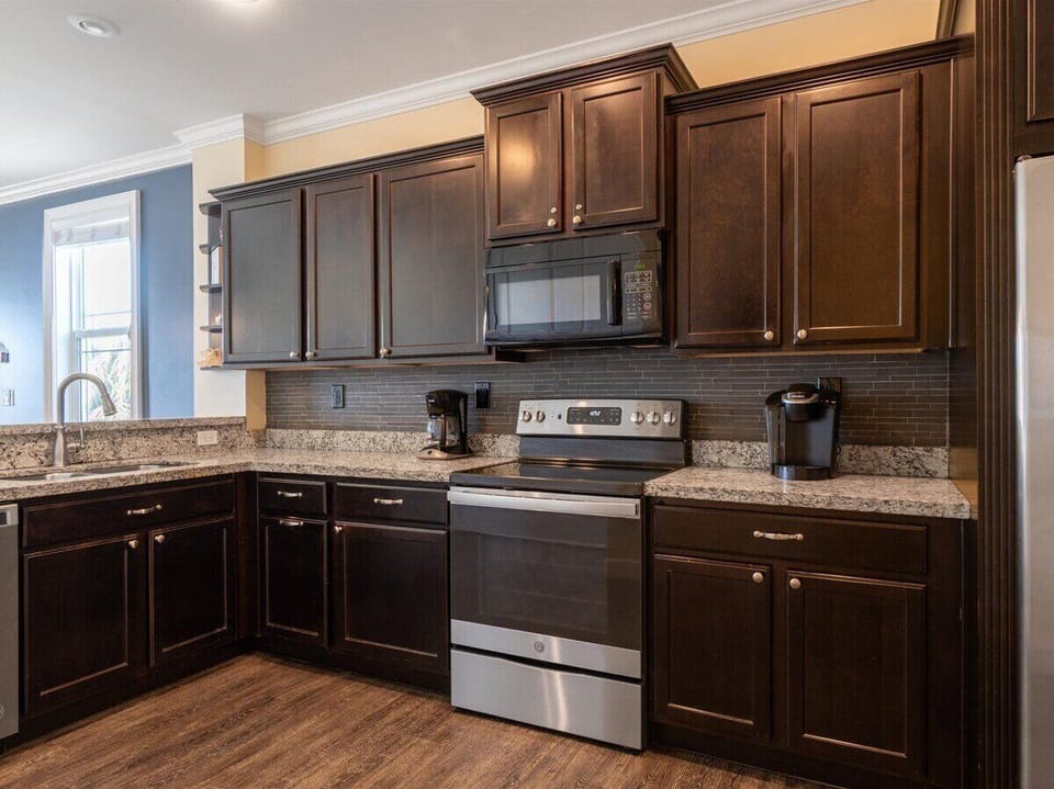 Cook in style with this sleek, modern kitchen featuring top-of-the-line stainless steel appliances.