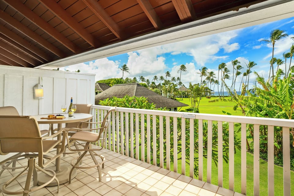 Lanai view of the ocean and lawn with outdoor dining area
