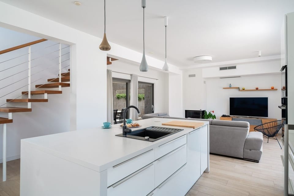 As you enter the ground floor, you're greeted by an expansive 60 sqm open-plan living area, 