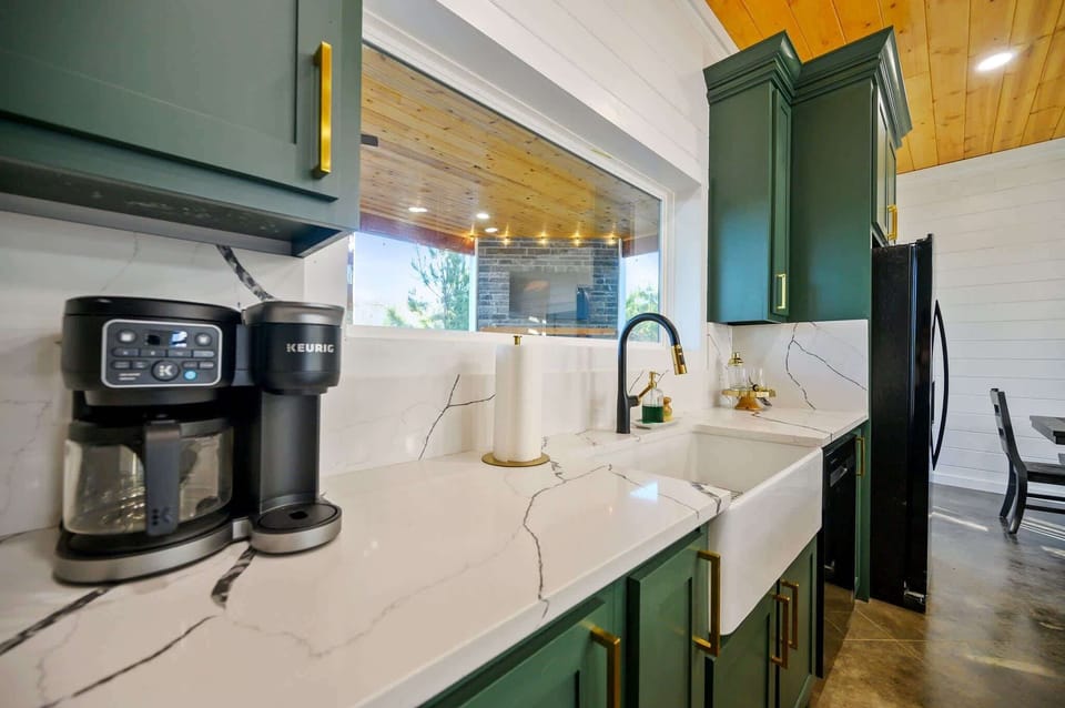 The chic, open kitchen offers ample space & all the comforts of home