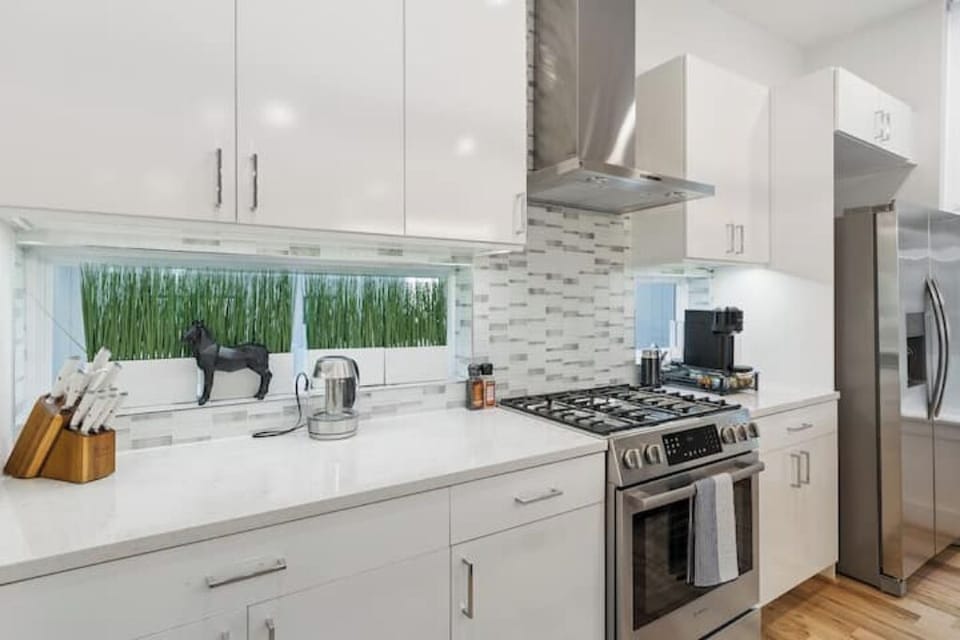 The all-white palette and stainless steel accents create a bright and airy feel
