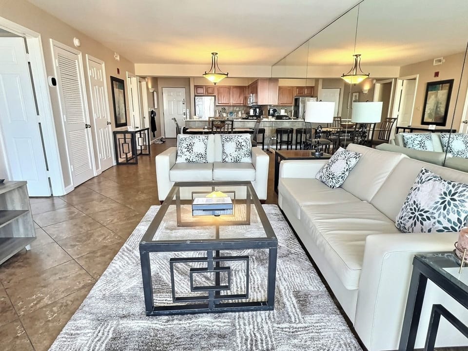 Spacious living room with a stunning Gulf view and modern furniture.