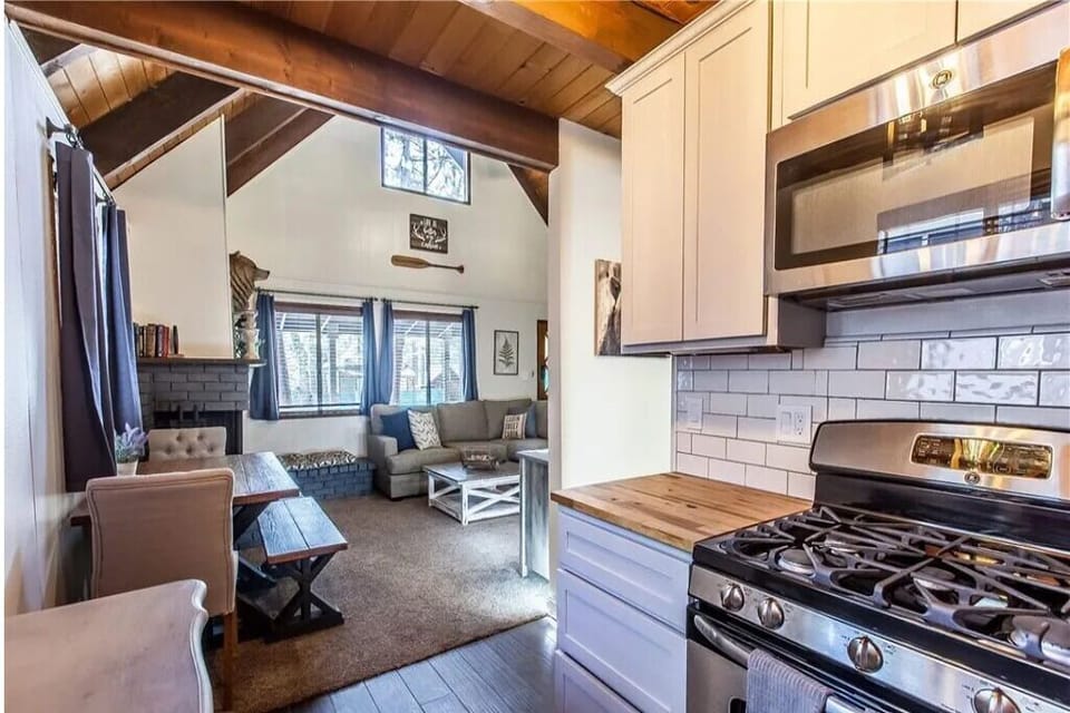 Kitchen open to living room with vaulted A-frame ceiling