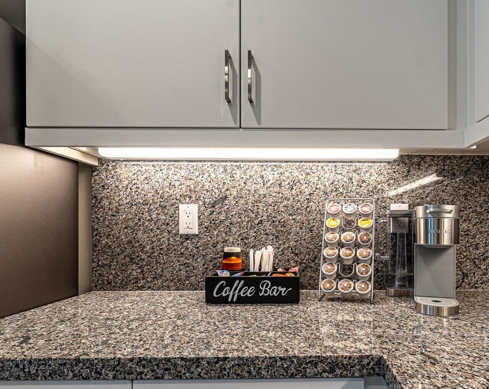 Coffee bar setup with a variety of pods and a sleek coffee maker.