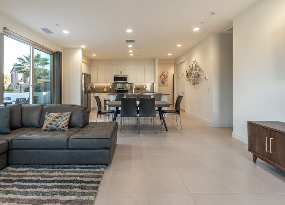 Open-concept living and dining area with modern furnishings and natural light.