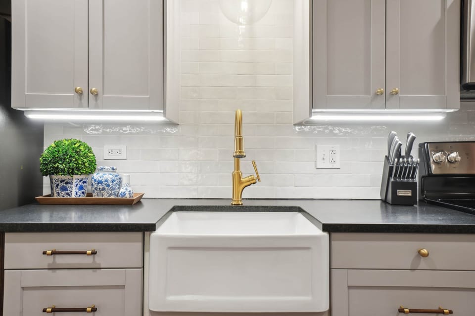 The custom kitchen has honed granite counters, under cabinet lighting, and hand-cut tile backsplash.