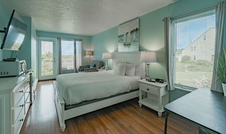 This bright and airy living space, with abundant natural light, is perfect for lounging and enjoying serene views.