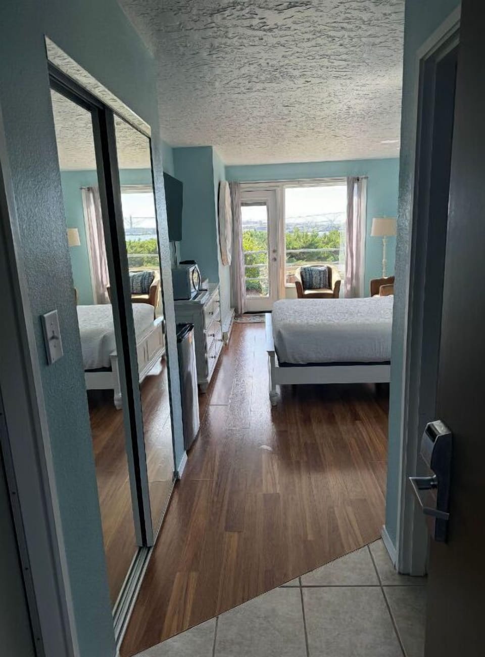 Bright hallway leading to spacious, sun-filled rooms with a relaxing atmosphere.