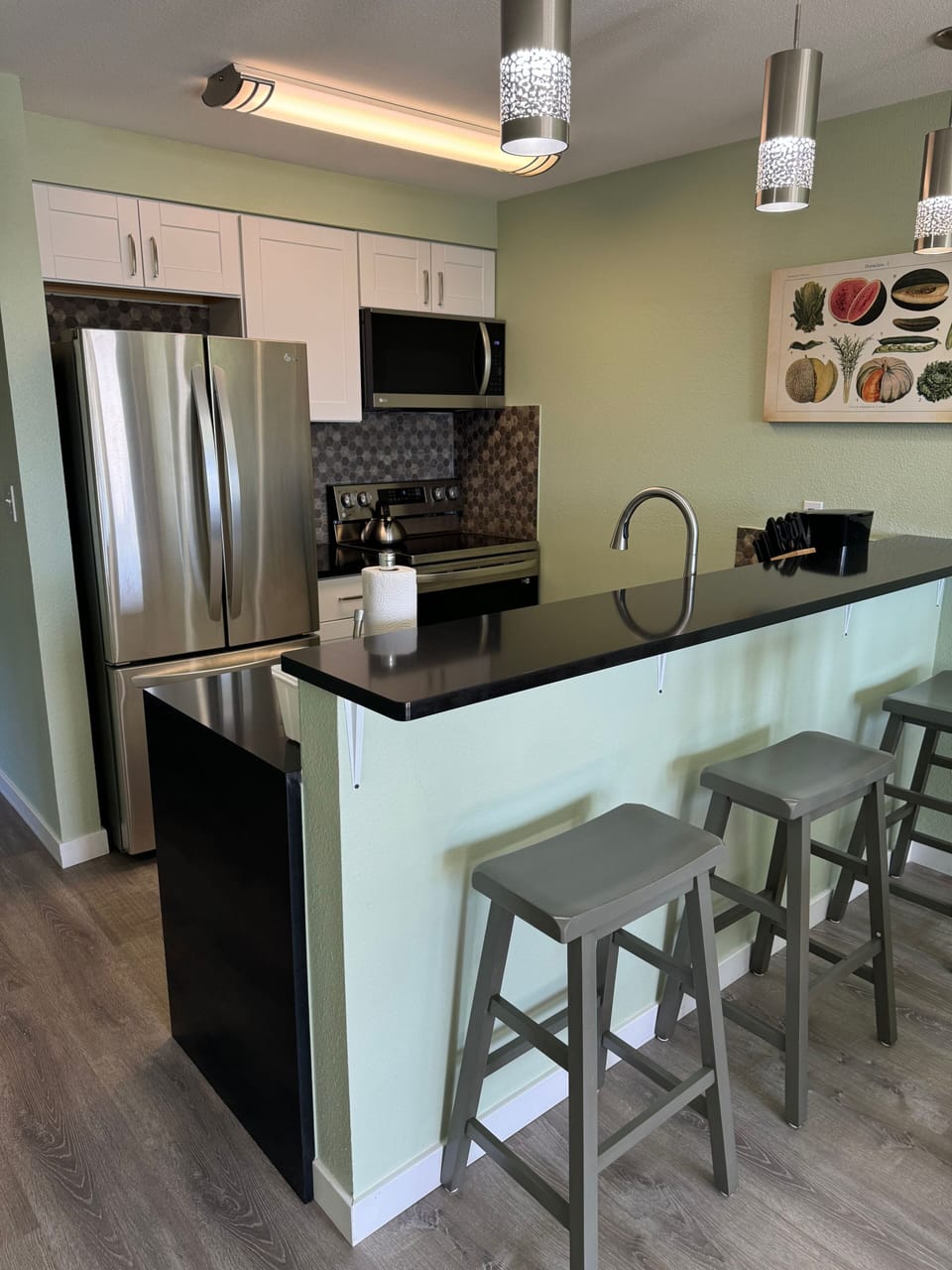 Modern kitchen with a spacious breakfast bar, ideal for casual dining or preparing meals.