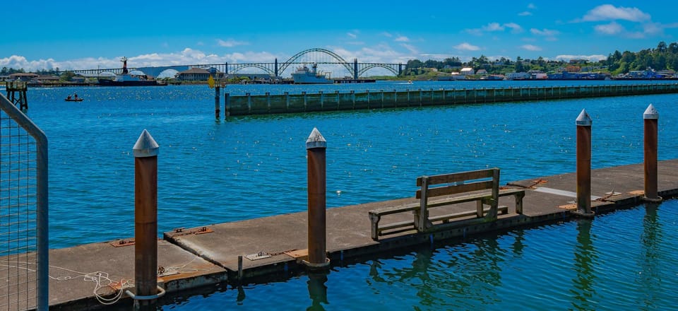 Take in the peaceful atmosphere of the docks, with endless blue skies and calm waters stretching ahead.