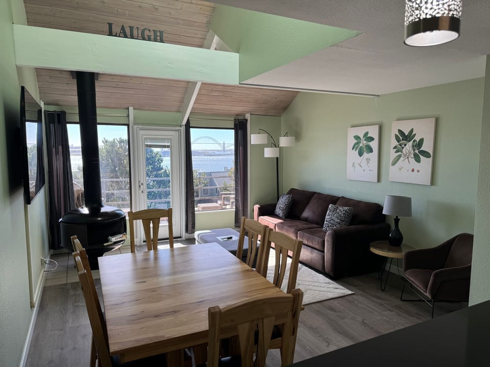 A bright, open living and dining area with plenty of natural light, perfect for gathering or relaxing.