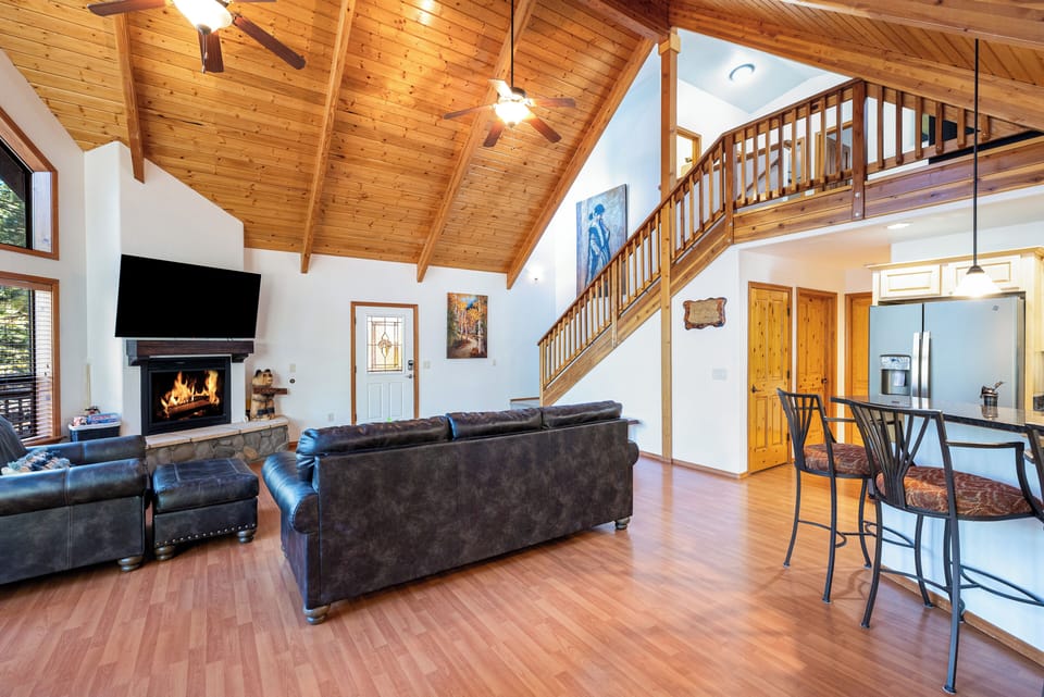 Gather around the floor-to-ceiling stone fireplace, sink into plush seating, or stream your favorite shows on the smart TV.