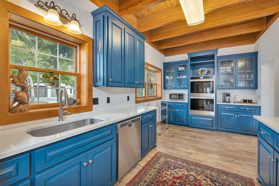 Blue kitchen with undermount sink and stainless dishwasher
