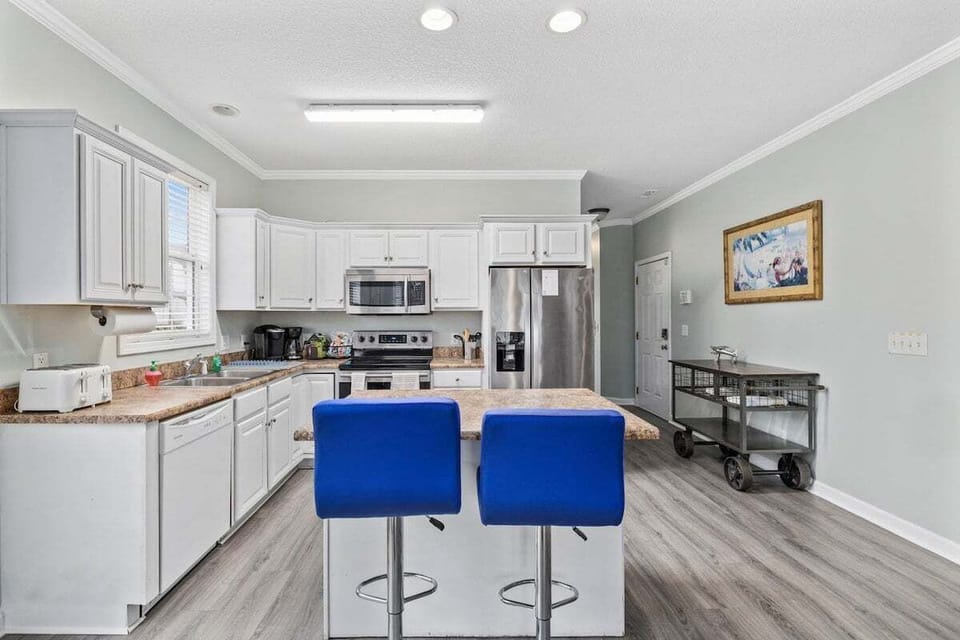 Spacious counters, modern appliances, and an island perfect for sipping wine while dinner simmers.