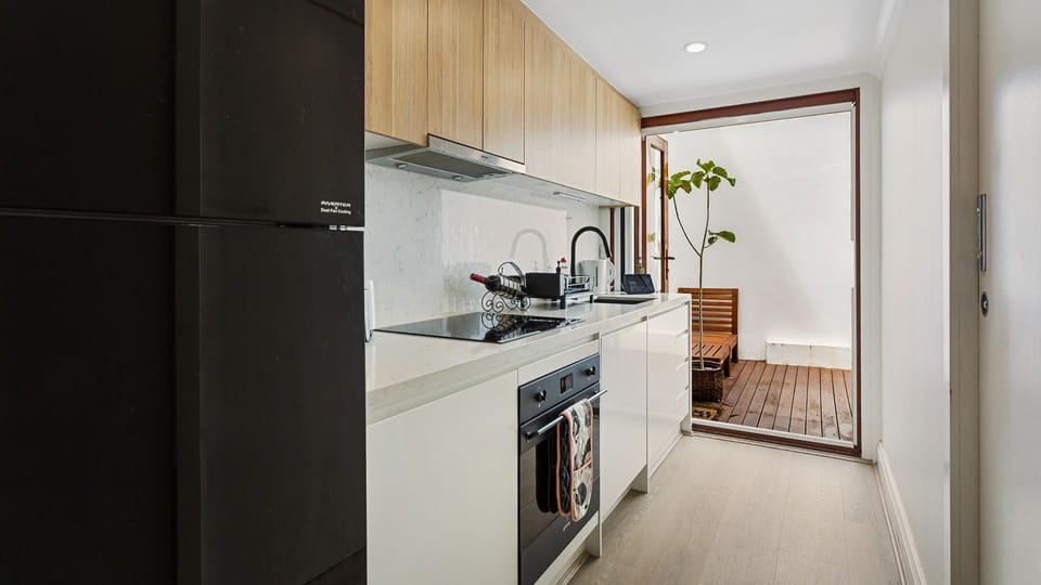 Modern kitchen with stove, oven, fridge, sink, and everything you need to cook!