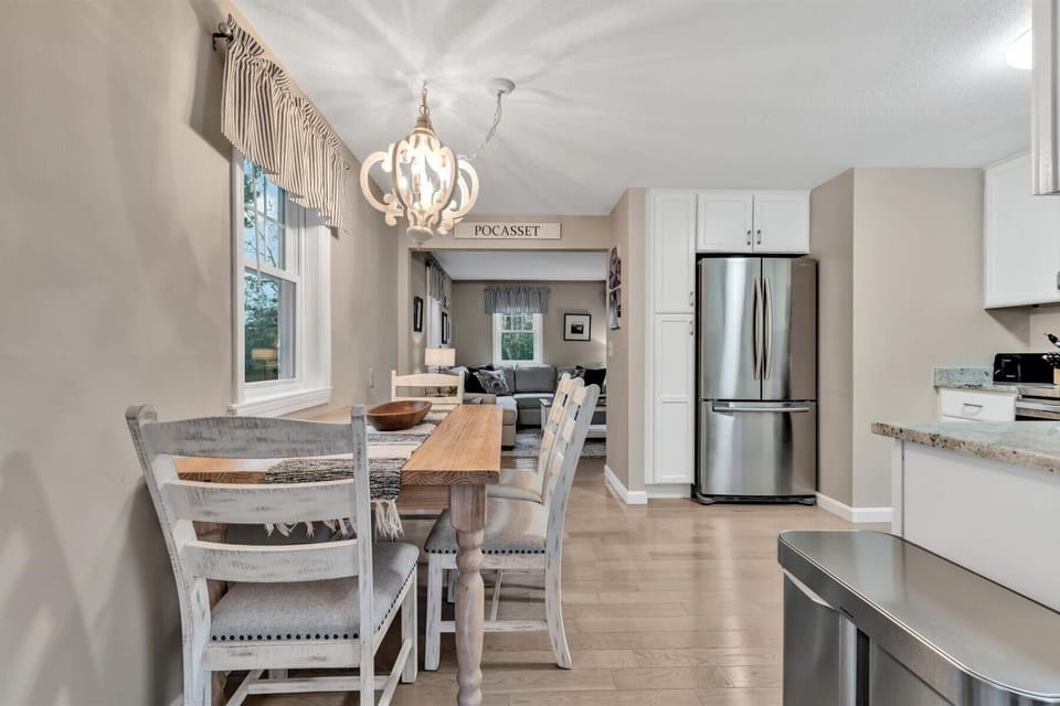 Enjoy meals together at this charming dining space, complete with elegant lighting and a cozy ambiance.