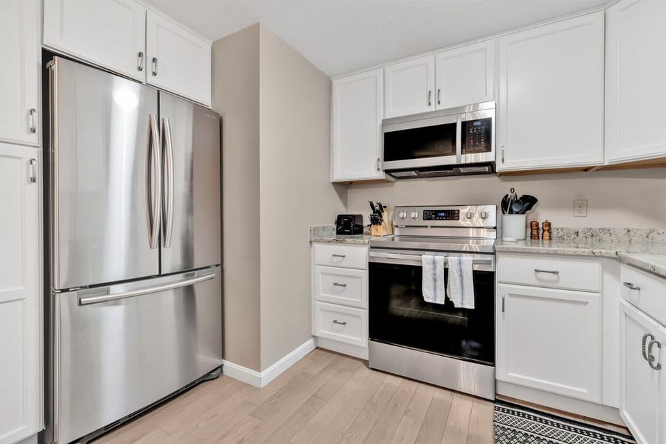 A fully equipped kitchen awaits, featuring sleek stainless steel appliances—perfect for crafting delicious meals during your stay.