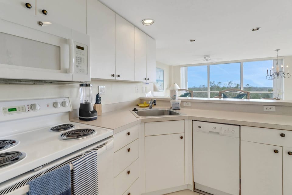 Cookware, dinnerware, many kitchen tools and small appliances are provided, including a drip coffee maker.